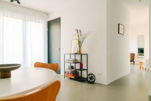 a white room with a table and chairs at Amsterdam Boutique Apartment in Amsterdam
