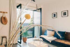 a living room with a vase with a plant at Amsterdam Boutique Apartment in Amsterdam +13 photos