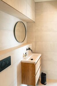 a bathroom with a sink and a mirror at Amsterdam Boutique Apartment in Amsterdam