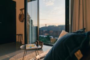 a room with a large glass window with a table at Amsterdam Boutique Apartment in Amsterdam