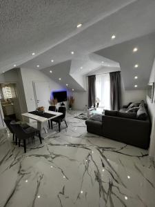 a living room with a couch and a table at Luxury Apartment Megy in Otočac