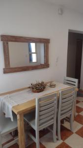 a dining room table with two chairs and a mirror at Casa Isabella in Villa Dolores