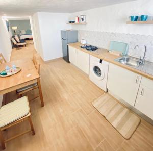 a kitchen with a sink and a table at Casa Gercko 1 in Yaiza