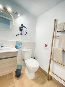 een badkamer met een toilet, een wastafel en een spiegel bij Casa Gercko 1 in Yaiza