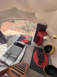 a tent with a bed and a table in it at Clear Sky Resorts - Grand Canyon - Unique Sky Domes in Valle