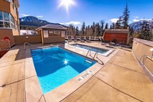 a swimming pool on the roof of a house at Le Chamois 510 Ski In&Out, Blackcomb Base, Newly Renovated, Common Pool, HotTub in Whistler