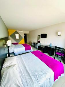 a hotel room with two beds and a desk at Hotel HAUS Ixtaczoquitlán in Orizaba +41 photos
