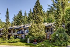 a house in the woods with trees at Telemark 8 in Whistler
