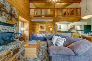 a living room with two couches and a fireplace at Telemark 8 in Whistler