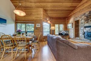 a dining room and living room in a log cabin at Telemark 8 in Whistler