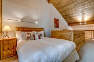 a bedroom with a large bed and a wooden ceiling at Telemark 8 in Whistler