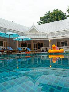 a swimming pool with a float in the middle of it at Tubtim Siam River Kwai Resort in Kanchanaburi
