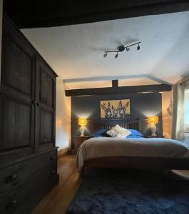 a bedroom with a large bed and a dresser at The Annexe in Winterbourne