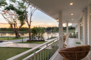 a porch with a view of the water at Tubtim Siam River Kwai Resort in Kanchanaburi