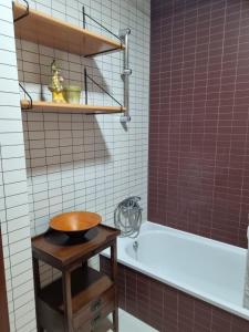 a bathroom with a tub and a toilet and a sink at Barosa rooms in Barro