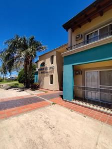 a building with a palm tree in front of it at Piedras del Lago in Federación