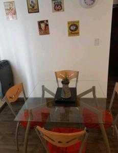 a glass table with a laptop on top of it at Departamento Centeno. Centrico. in Santa Rosa