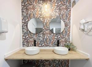 a bathroom with two sinks and two mirrors at A TROITA HOSTEL Only Pilgrims Solo Peregrinos in Tui +38 photos