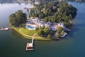 a large house on an island in the water at Lakefront Luxury Villa in Alexander City