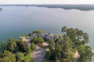 an aerial view of a large house on the water at Lakefront Luxury Villa in Alexander City