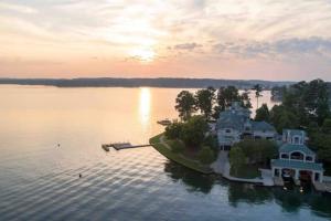 a large house on an island in the water at Lakeside Grande Villa in Alexander City
