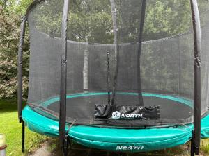 a trampoline with a net on top of it at The Blomsholm Cabin in Strömstad