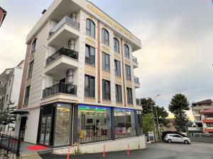 a tall white building with a lot of windows at Cerrahpasa Apart Hotel in Trabzon