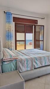 a bedroom with a bed with a view of the ocean at Oued Laou Apartment in Oued Laou