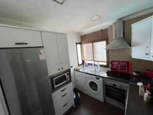 A kitchen or kitchenette at Panoramic Ocean View Apartment