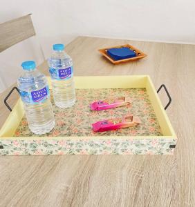 a tray with two bottles of water on a table at Casa Gercko 2 in Yaiza