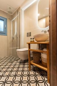 a bathroom with a sink and a tub and a toilet at Mosaic Luxury Home in Rhodes Town