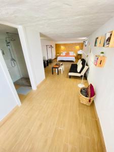 a large living room with a bed and a couch at Casa Gercko 3 in Yaiza