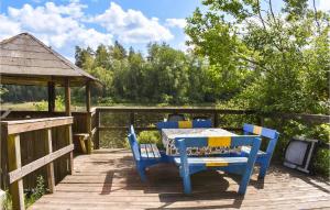 a table and chairs on a deck with a gazebo at Pet Friendly Home In Backaryd With House A Panoramic View in Backaryd