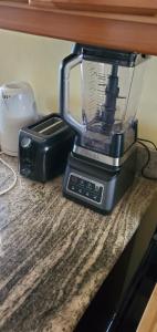 a blender and a toaster sitting on a counter at Nation Palace house rentals in Montego Bay