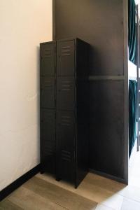 two black lockers in a room next to a wall at RIO HOSTEL in Guatemala
