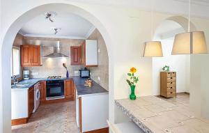 a kitchen with an archway and a kitchen with a counter at The Willows in Alicante