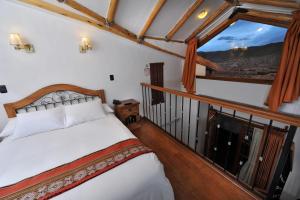 a bedroom with a bed and a large window at Casa San Blas Cusco Exquisite By Xima in Cusco