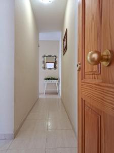 a hallway with a door and a mirror and a table at Las Teresitas Apartment in San Andrés