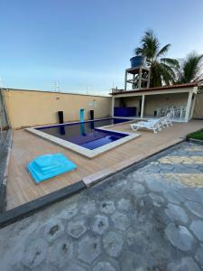 a house with a swimming pool and a house at Dunas Residence Casa n16 in Santo Amaro