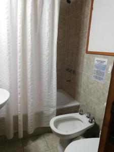 ein Badezimmer mit Toilette, Waschbecken und Badewanne in der Unterkunft Cabañas Alegra 1 in San Martín de los Andes + 11 Fotos