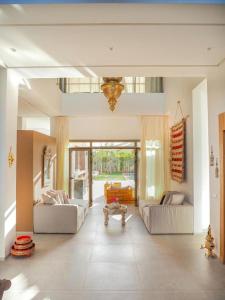 uma grande sala de estar com dois sofás e uma mesa em Villa Emraulde em Marrakech