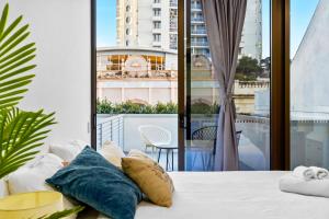 a bedroom with a bed and a large window at Arthur's Hotel Bondi Junction in Sydney