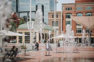 a fountain in the middle of a city with buildings at Stunning 2 bedroom Downtown Ft Worth in Fort Worth