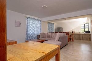 a living room with a couch and a table at Lotus Lane Apartments in Grand-Baie