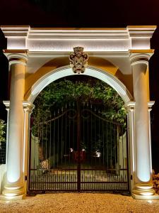 an archway with a gate with a tree behind it at Masseria Principe di Puglia in San Vito dei Normanni