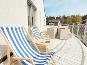 two rocking chairs sitting on a patio on a balcony at Duplex apartment, 3 bedrooms, pool, Pobierowo in Pobierowo