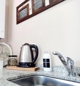 a kitchen counter with a tea kettle and a sink at Rincón de Paz Apart & Loft Suite Boutique - Adults Only in Villa Carlos Paz