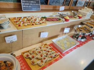 a buffet with many different types of food on display at Saga City Hotel in Saga