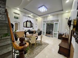 a living room with a table and chairs at VINTAGE HOUSE (Full house) in Xuan An