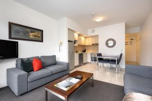 a living room with a couch and a table at Lantern 1 Bedroom Balcony with breathtaking view in Thredbo